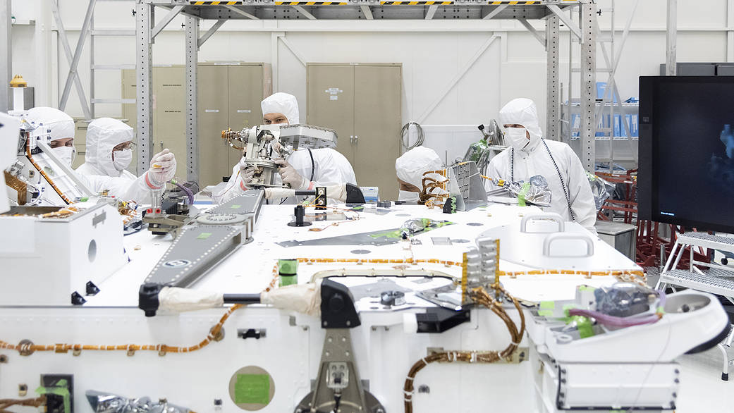 Mars 2020 engineers and technicians prepare the high-gain antenna for installation on the rover's equipment deck