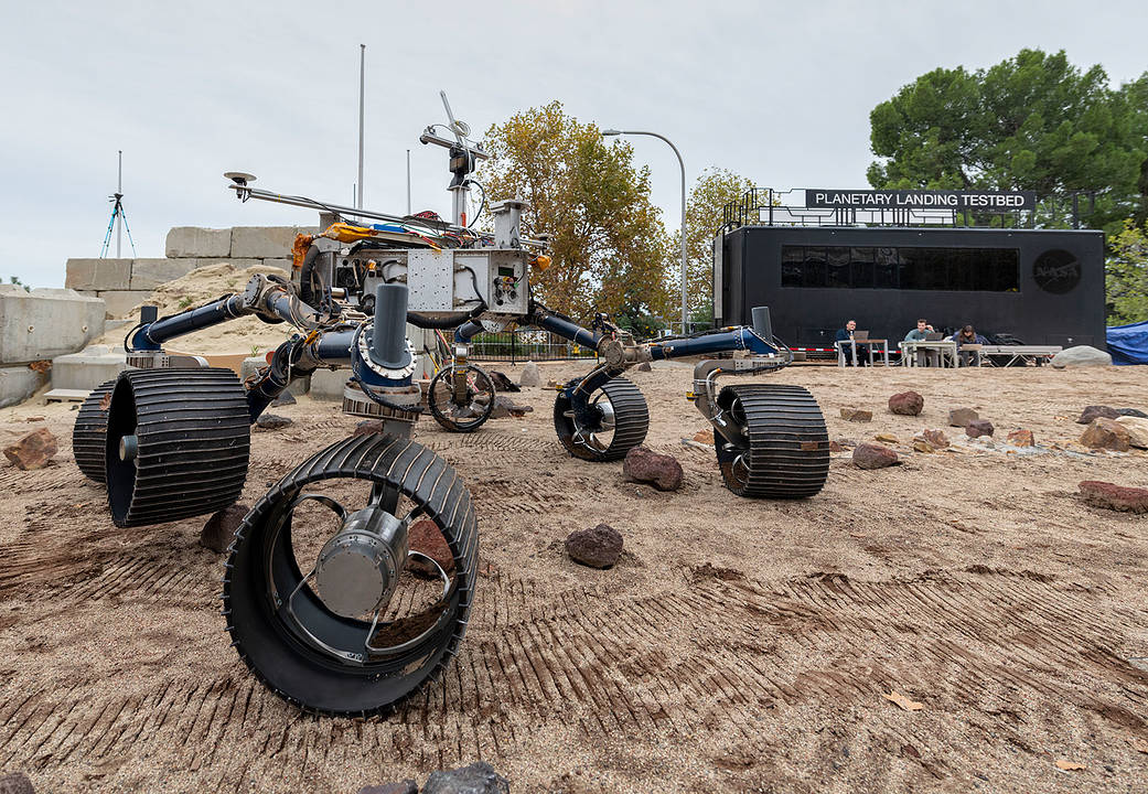 An engineering model of NASA's Mars 2020 rover makes tracks during a driving test in the Mars Yard