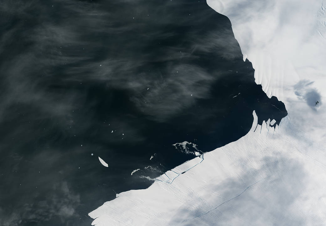 Image from orbit of Antarctic coast with piece of glacier breaking free