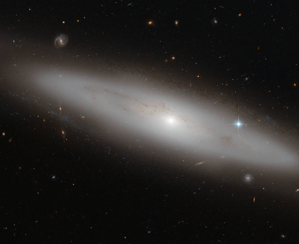 creamy pale galactic disk foreshortened and angled down to the right