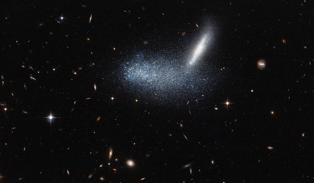 a starfield, centered on a horizontal blur of bluish light and bright streak up to the right