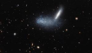 a starfield, centered on a horizontal blur of bluish light and bright streak up to the right