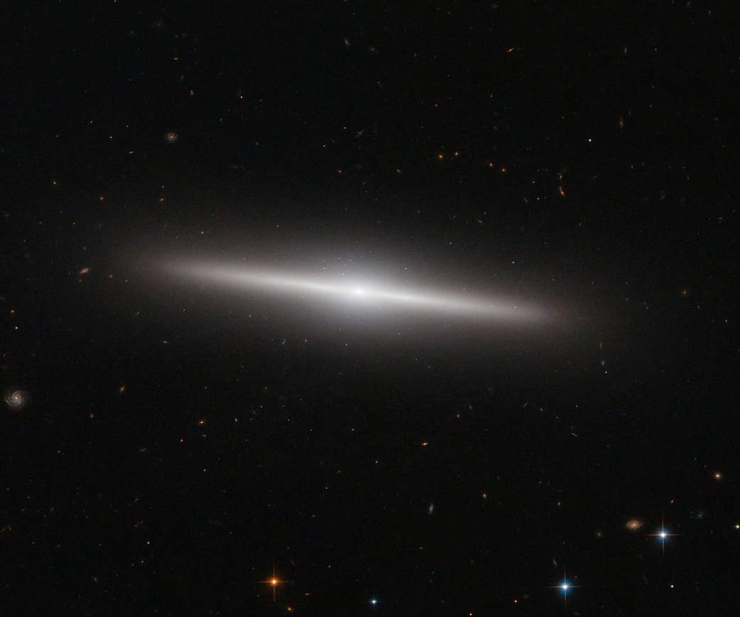 a delicate side-on galaxy in a field of black