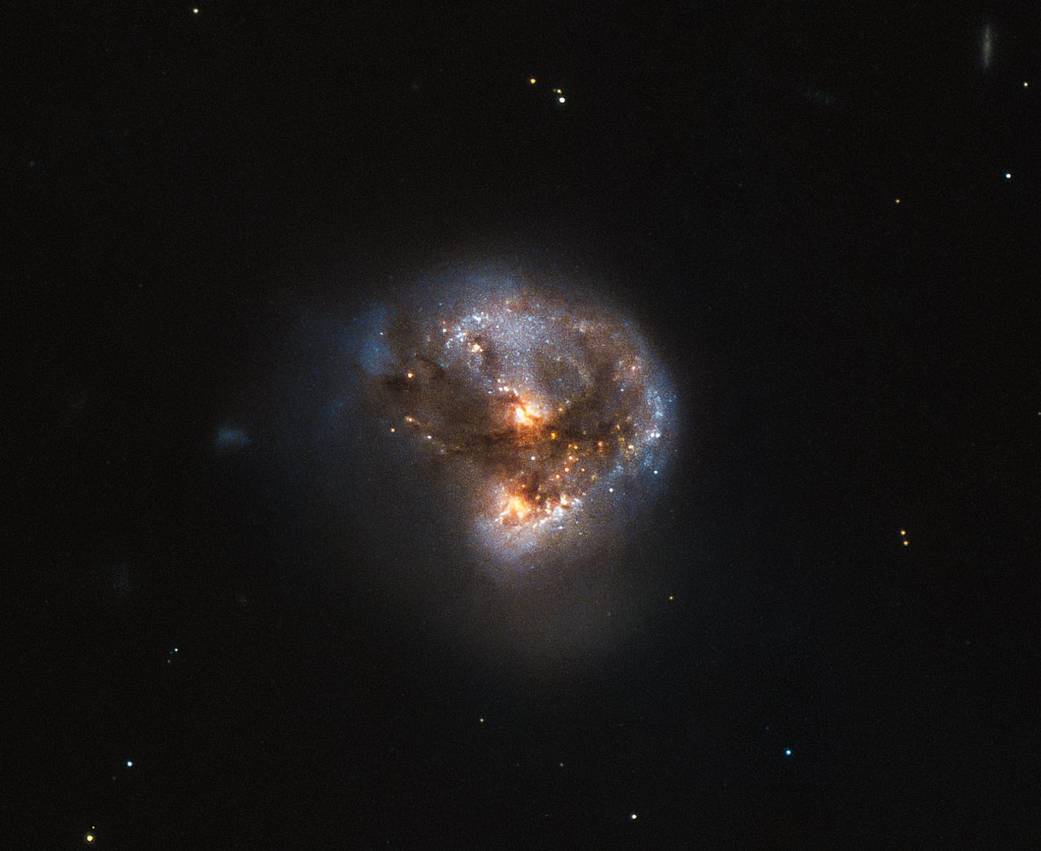 tight cluster of yellow and blue stars wreathed in dust