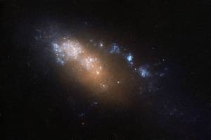 an orange-white smear of stars trailing blue-white spots