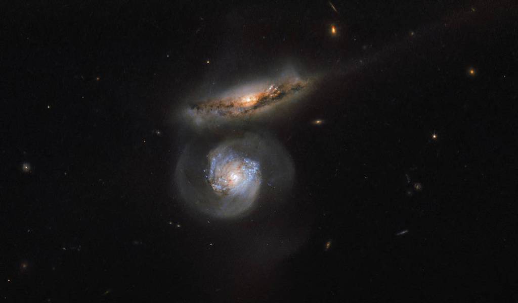 two galaxies, one head on and one edge on