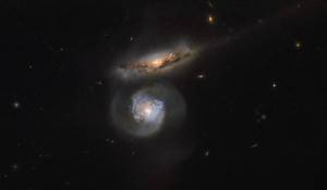two galaxies, one head on and one edge on
