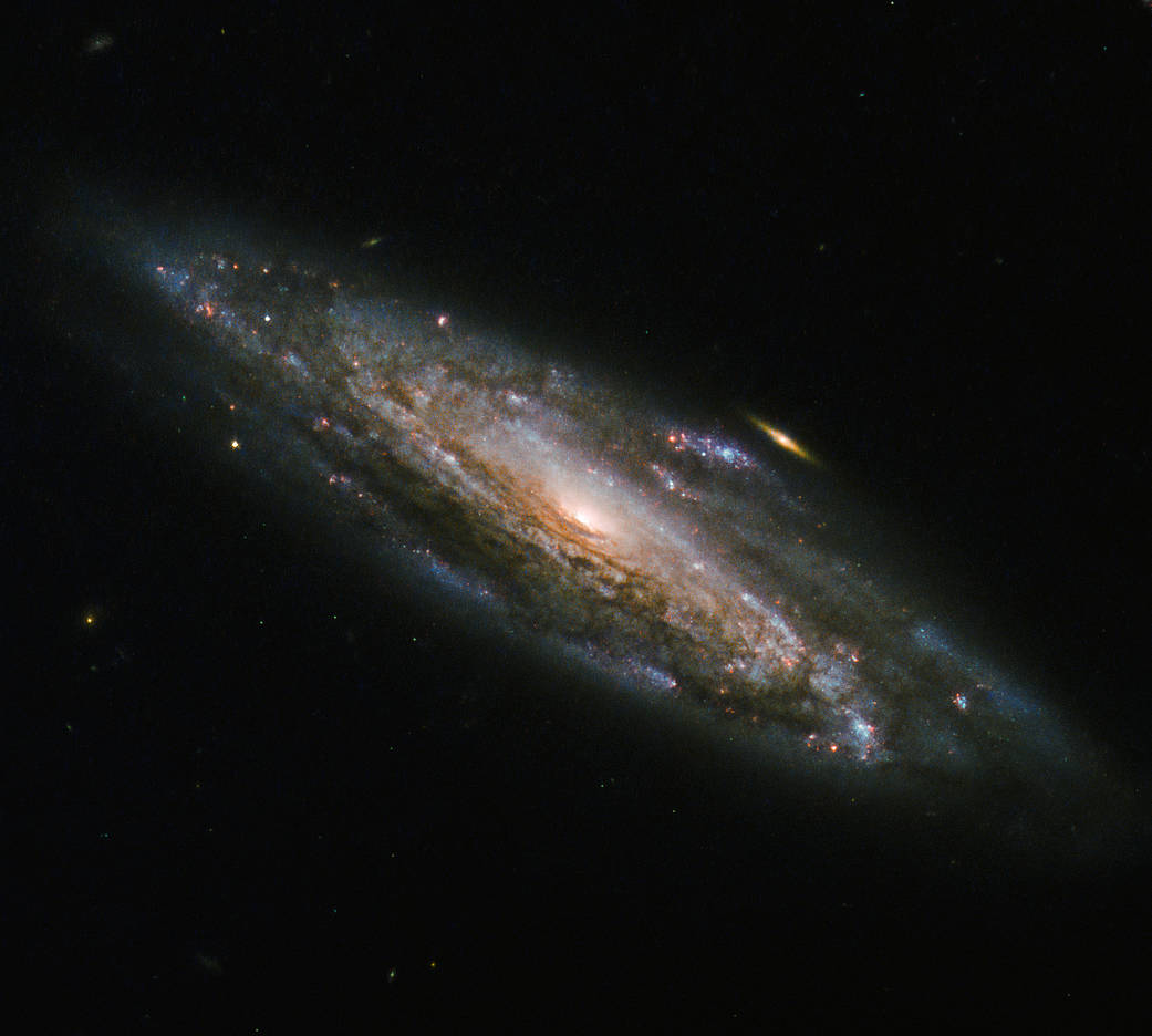 spiral galaxy with small golden galaxy in background