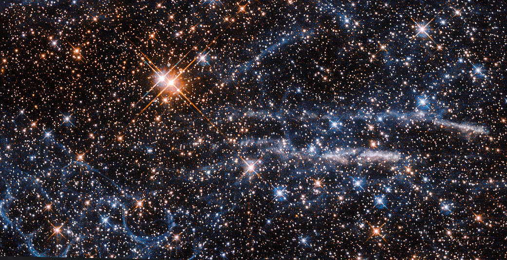 bright stars, wispy blue waves and orange mass