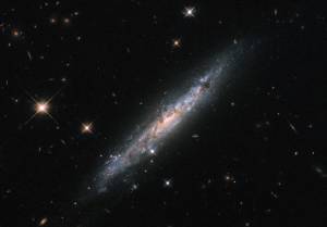 diagonal edge-on galaxy with bright scattered foregeround stars
