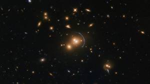 fuzzy orange blobs on black, with a blue arc around one