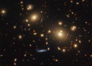 cluster of amber and blue galaxies, some distorted