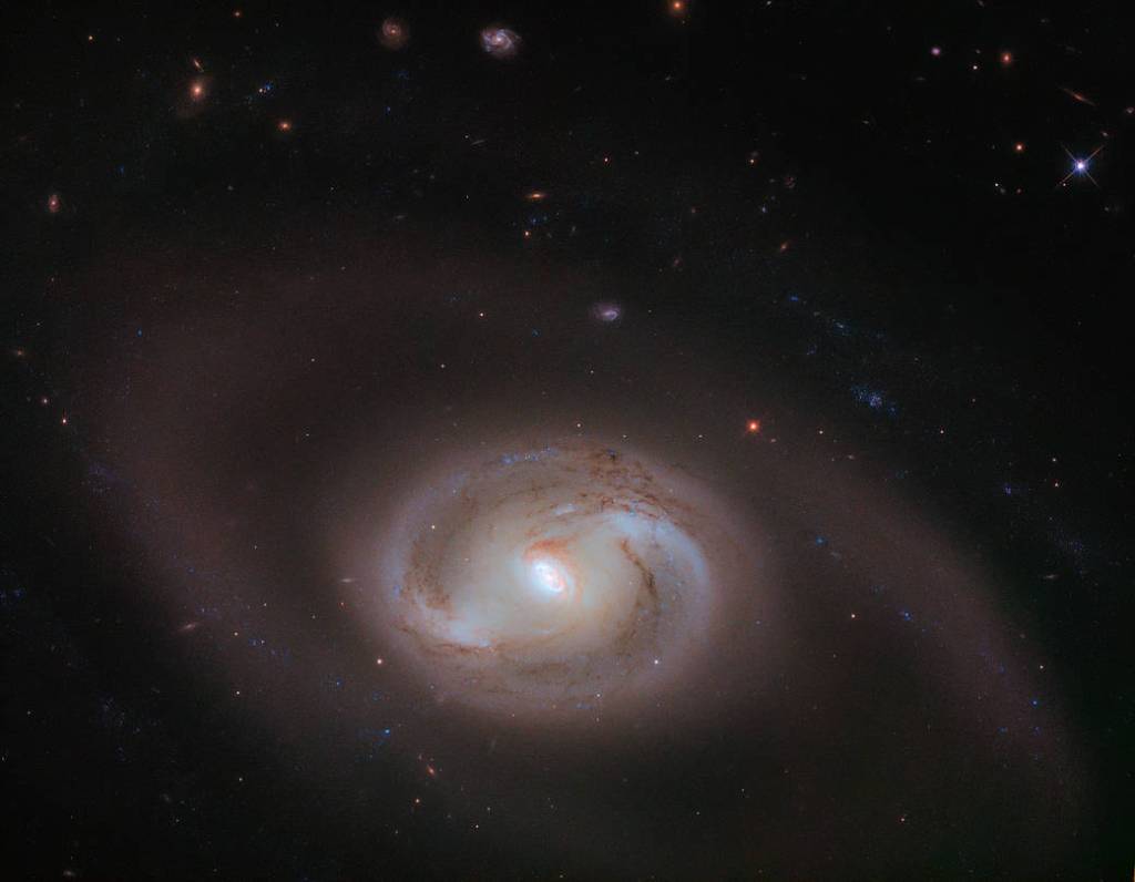 Hubble image of NGC 2273: bright spiral shapes against black backdrop of space
