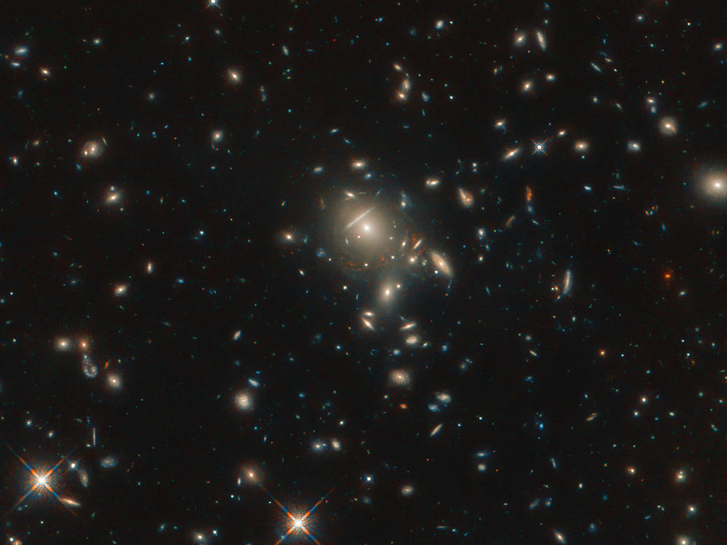 starburst galaxy PLCK G045.1+61.1 (a bunch of bright smears of light against the black backdrop of space)