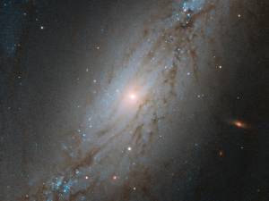 barred spiral galaxy NGC 7513, against black backdrop of space