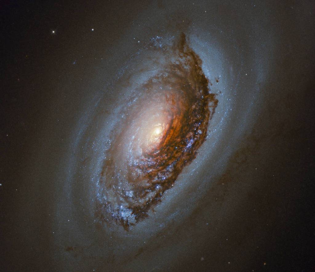 This image taken with the NASA/ESA Hubble Space Telescope features NGC 4826, a spiral galaxy located 17 million light-years away