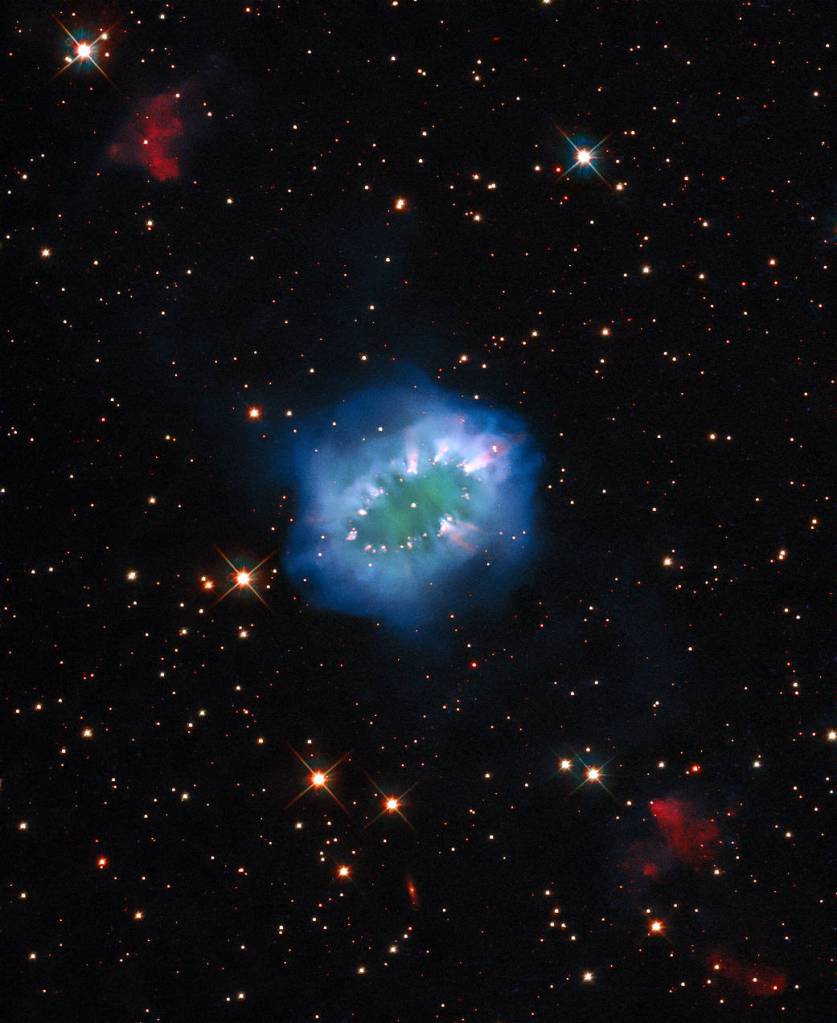 The interaction of two doomed stars has created this spectacular ring adorned with bright clumps of gas ¬– a diamond necklace of cosmic proportions. 