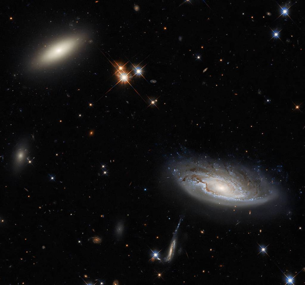 Two enormous galaxies capture your attention in this spectacular image taken with the NASA/ESA Hubble Space Telescope using the Wide Field Camera 3 (WFC3).