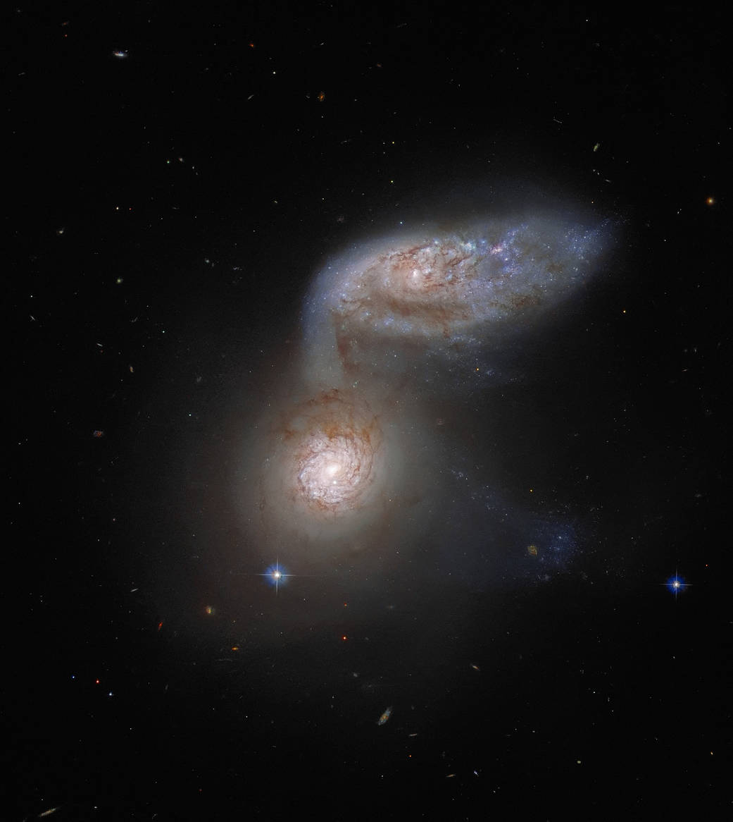 This NASA/ESA Hubble Space Telescope image features two interacting galaxies that are so intertwined, they have a collective name – Arp 91. Their delicate galactic dance takes place more than 100 million light-years from Earth. 