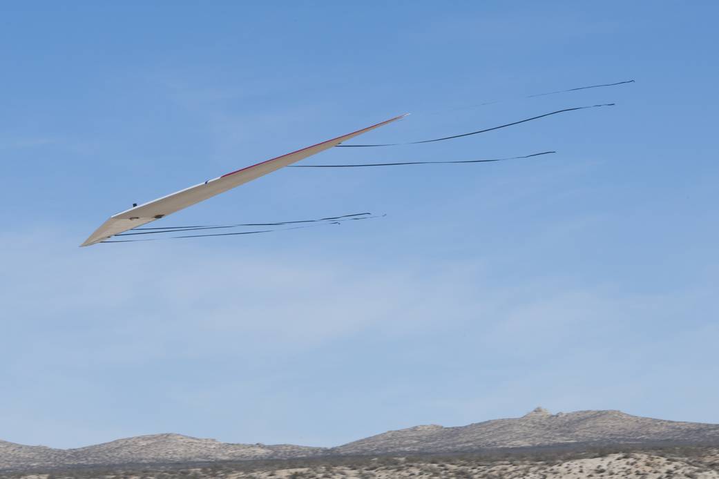 During a test flight of the radio-controlled Prandtl-D No. 3 research aircraft, streamers provide ground observers information.