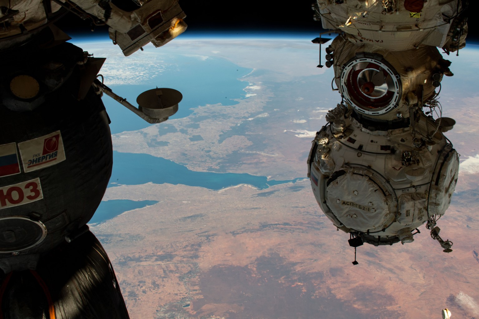 The Prichal docking module from Roscosmos is pictured attached to the Nauka multipurpose laboratory module as the International Space Station orbited 264 miles above South Australia. The three major bodies of water seen in this photograph are, from top to bottom, the Great Australian Bight, Spencer Gulf, and St. Vincent Gulf. At left, is a portion of the Soyuz MS-19 crew ship docked to the Rassvet module.