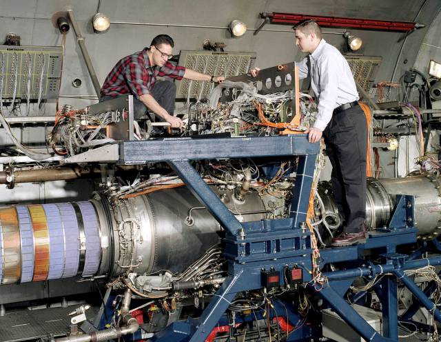 Technical staff sets up an F-405 engine in the Propulsion Systems Laboratory