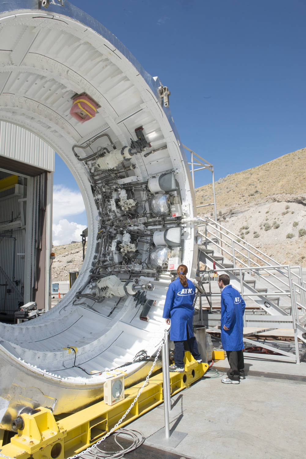 Test technicians at ATK's facility in Promontory, Utah, examine the SLS booster aft skirt.