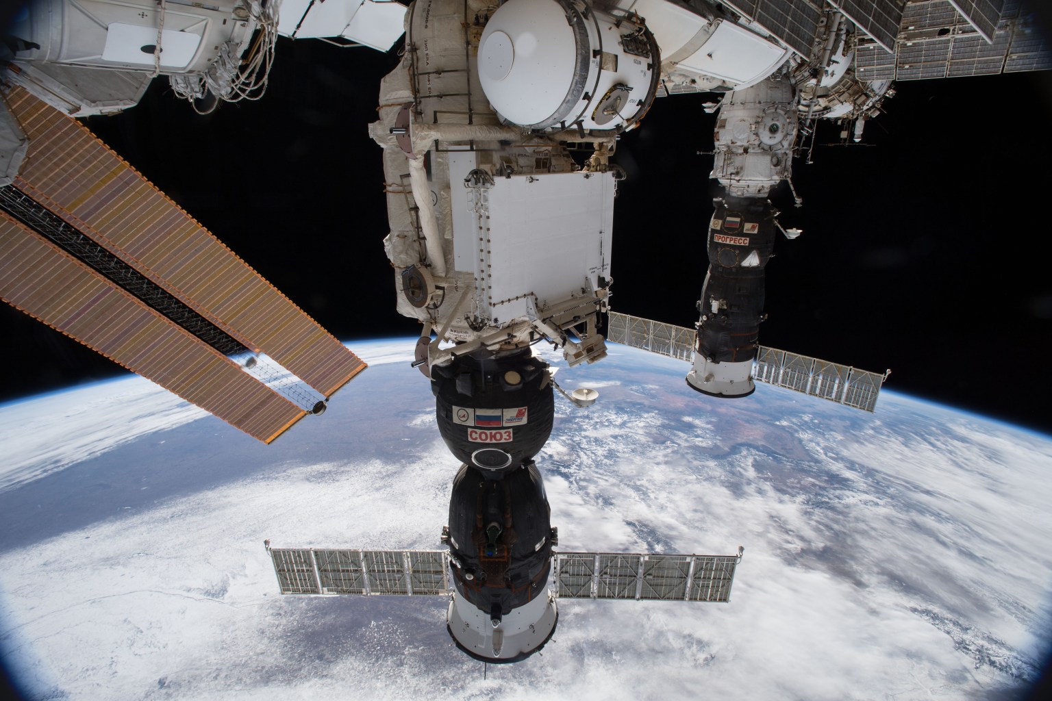 Russia's Soyuz MS-07 crew ship (foreground) and Progress 68 cargo craft are seen docked to the Earth-facing ports of the International Space Station's Russian segment. The Soyuz is docked to the Rassvet module and the Progress is attached to the Pirs docking compartment. The space station was orbiting 253 miles above the northern United States when this photograph was taken by an Expedition 54 crew member.