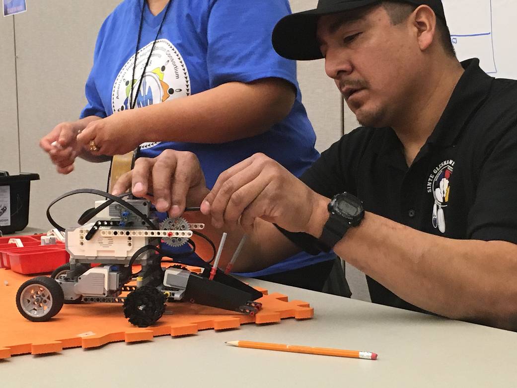 A student from Sinte Gleska University works to build a model rover for a NASA Community College Aerospace Scholars (NCAS) Rover