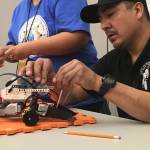 A student from Sinte Gleska University works to build a model rover for a NASA Community College Aerospace Scholars (NCAS) Rover