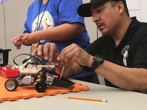 A student from Sinte Gleska University works to build a model rover for a NASA Community College Aerospace Scholars (NCAS) Rover