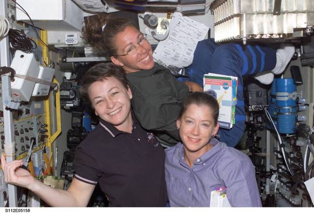 Three women pose for photograph aboard International Space Station