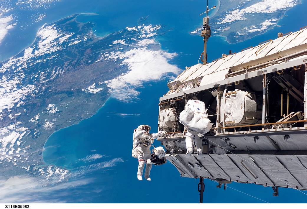 Shuttle Spacewalkers Work Outside Station