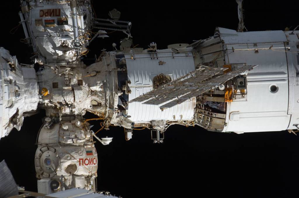 The International Space Station’s Zvezda service module is pictured with two Russian modules attached to its forward section