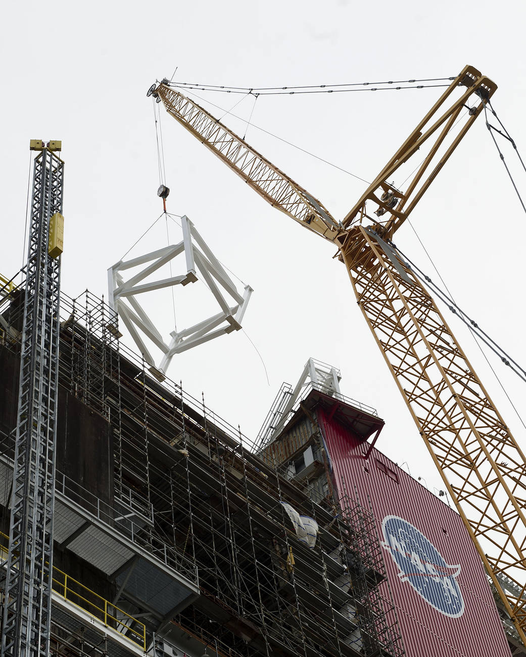 Crane adding steel structure to B-2 stand