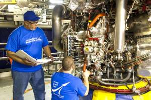 Aerojet Rocketdyne technicians inspect the engine controller