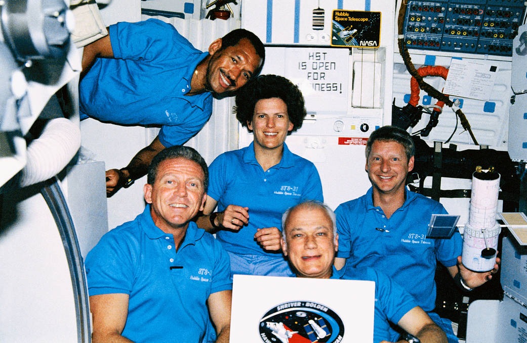 Five astronauts aboard space shuttle pose for photo