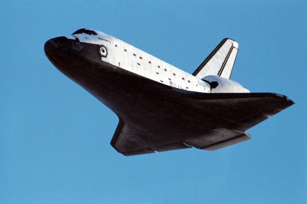 Shuttle Discovery about to touch down for landing against blue sky