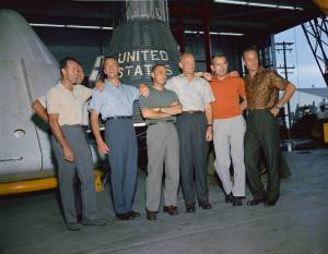 Original Mercury astronauts stand in group for photo in front of spacecraft 