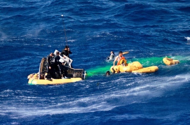 The Gemini 3 capsule floats in the ocean after its space flight