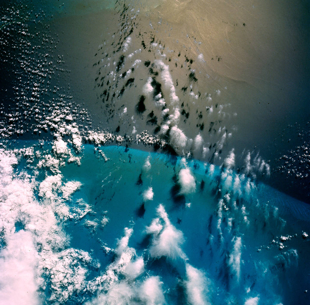 Coastline and blue water with clouds above