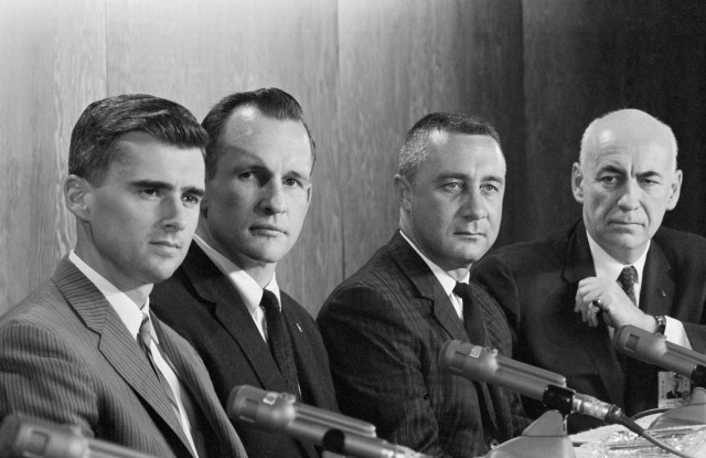 Black and white photo - Manned Spacecraft Center Director Robert R. Gilruth (far right) introduces the Apollo 1 crew during press conference in Houston. Sitting next to Gilruth are (from left) astronauts Roger Chaffee, Edward H. White II, and Gus Grissom sitting in front of microphones. (1966)