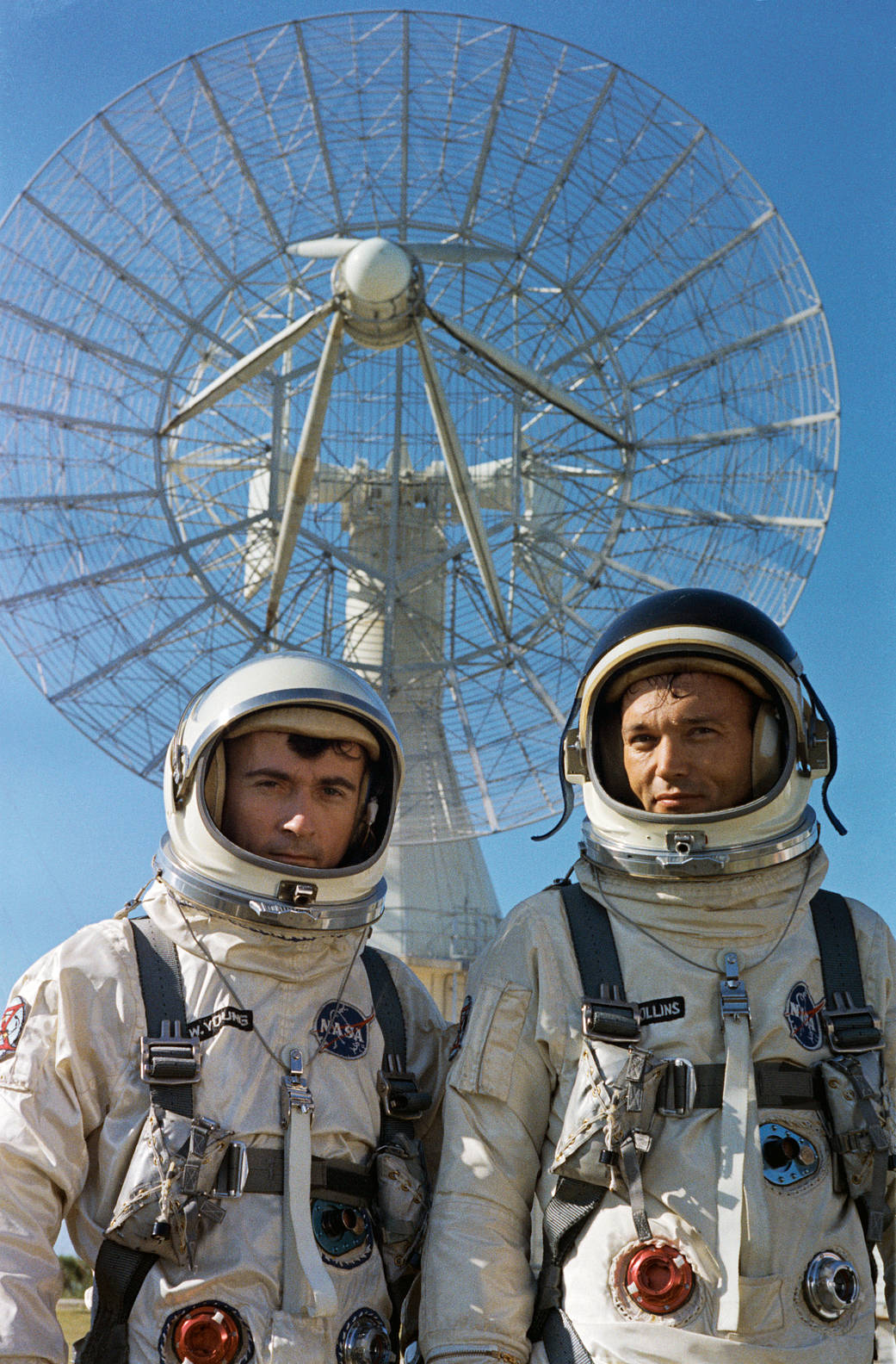 Two astronauts in spacesuits with helmets pose for photograph
