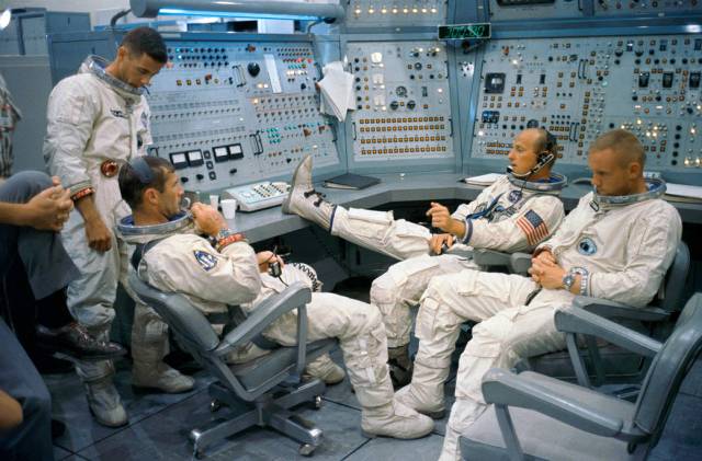 Astronauts in spacesuits inside spacecraft simulator