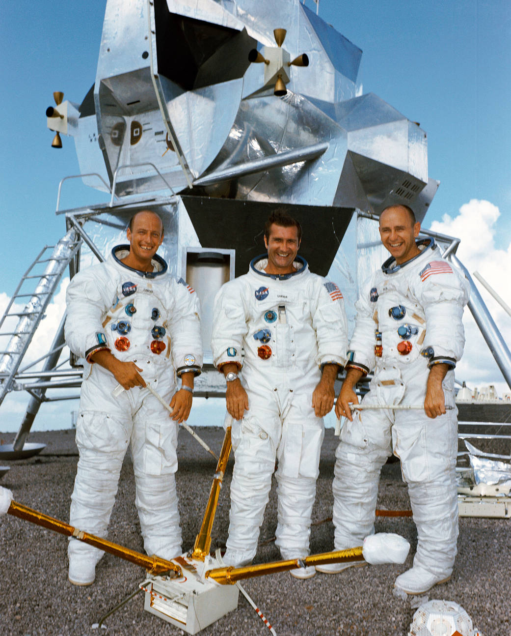 Apollo 12 crew portrait in spacesuits with lunar lander mockup