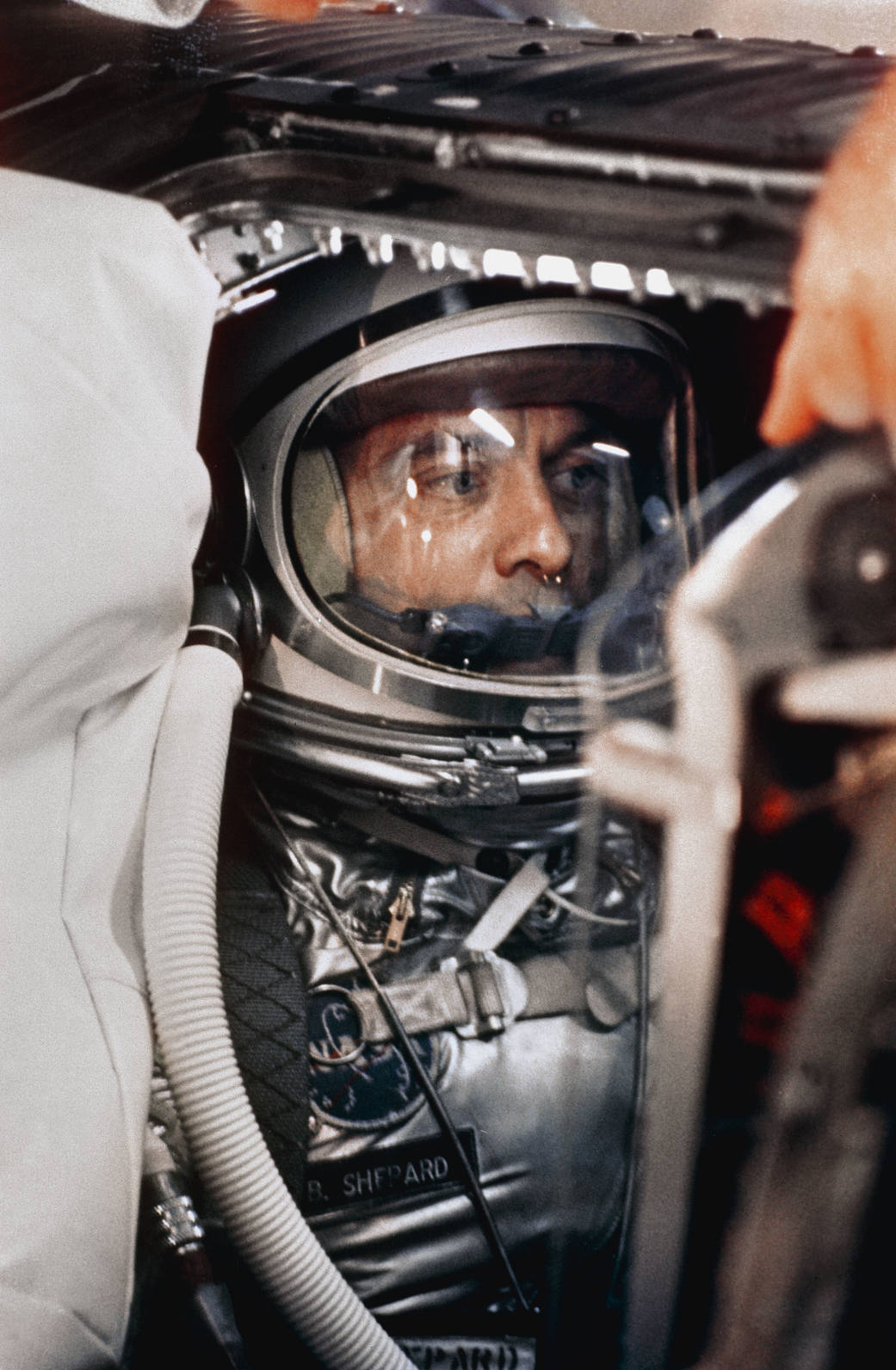 Closeup of astronaut Alan Shepard in spacesuit inside Mercury capsule