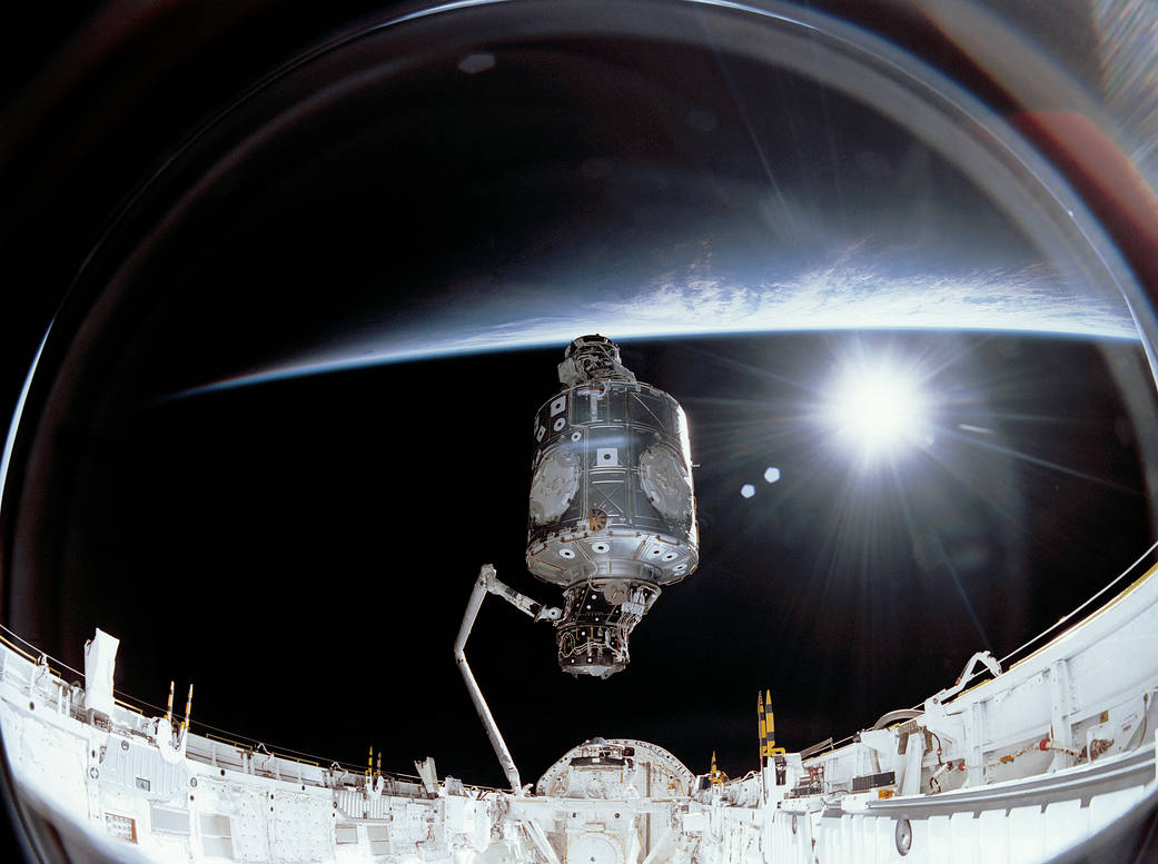 On Dec. 6, 1998, the crew of space shuttle mission STS-88 began construction of the International Space Station, attaching the U.S.-built Unity node and the Russian-built Zarya module together in orbit. The crew carried a large-format IMAX® camera, used to take this image of Unity lifted out of Endeavour's payload bay to position it upright for connection to Zarya. Zarya, launched on Nov. 20, 1998, was the first piece of the International Space Station. Also known as the Functional Cargo Block (FGB), it would provide a nucleus of orientation control, communications and electrical power while the station waited for its other elements. Two weeks later, on Dec. 4, 1998, NASA's space shuttle Endeavour launched Unity, the first U.S. piece of the complex, during the STS-88 mission.