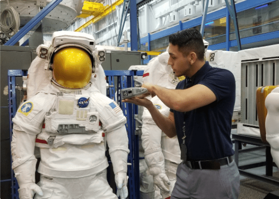 Pathways Intern looking at NASA Space Suit