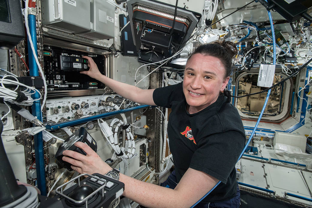 image of astronaut working with experiment