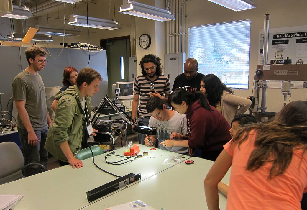 Students working on the Arduino Project learn how to solder